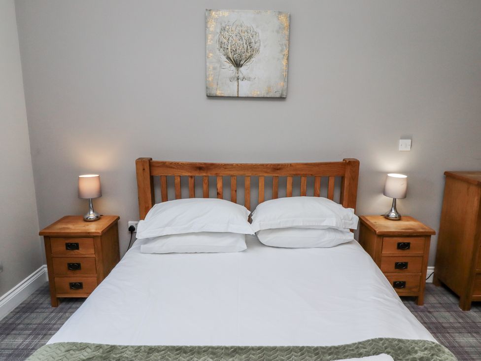 A bedroom with a bed and bedside tables at Red Fox in Lucker