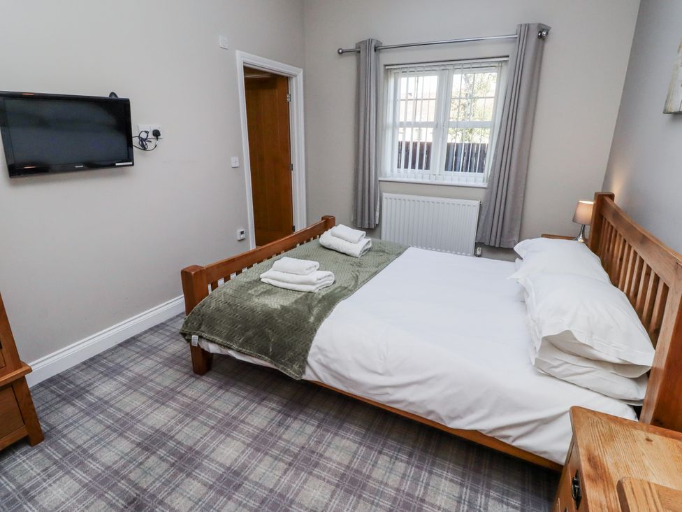 A bedroom with a bed and television at Red Fox in Lucker