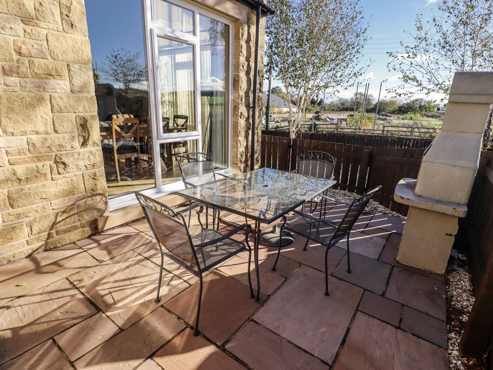 An outdoor patio with a table and chairs at Red Fox in Lucker