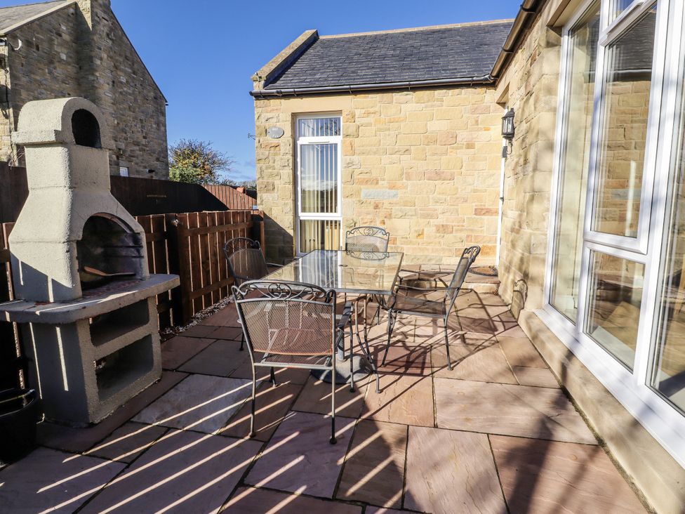 An outdoor seating area with a table and chairs at Red Fox in Lucker