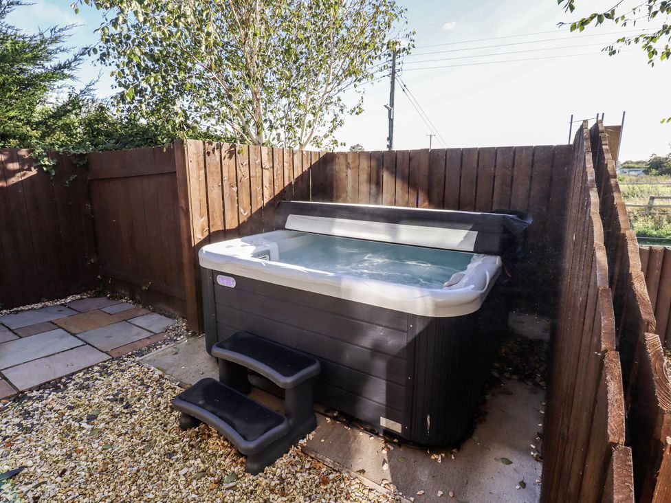 An outdoor area with a hot tub and steps at Red Fox in Lucker