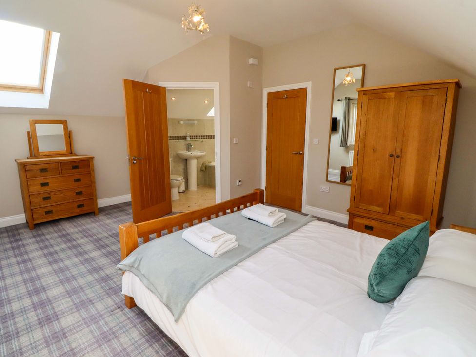 A bedroom with a bed and furniture at Roe Deer in Lucker