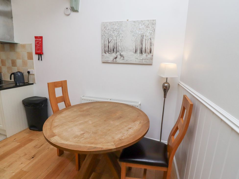 A dining room with a round table and two chairs at Chiff Chaff in Lucker