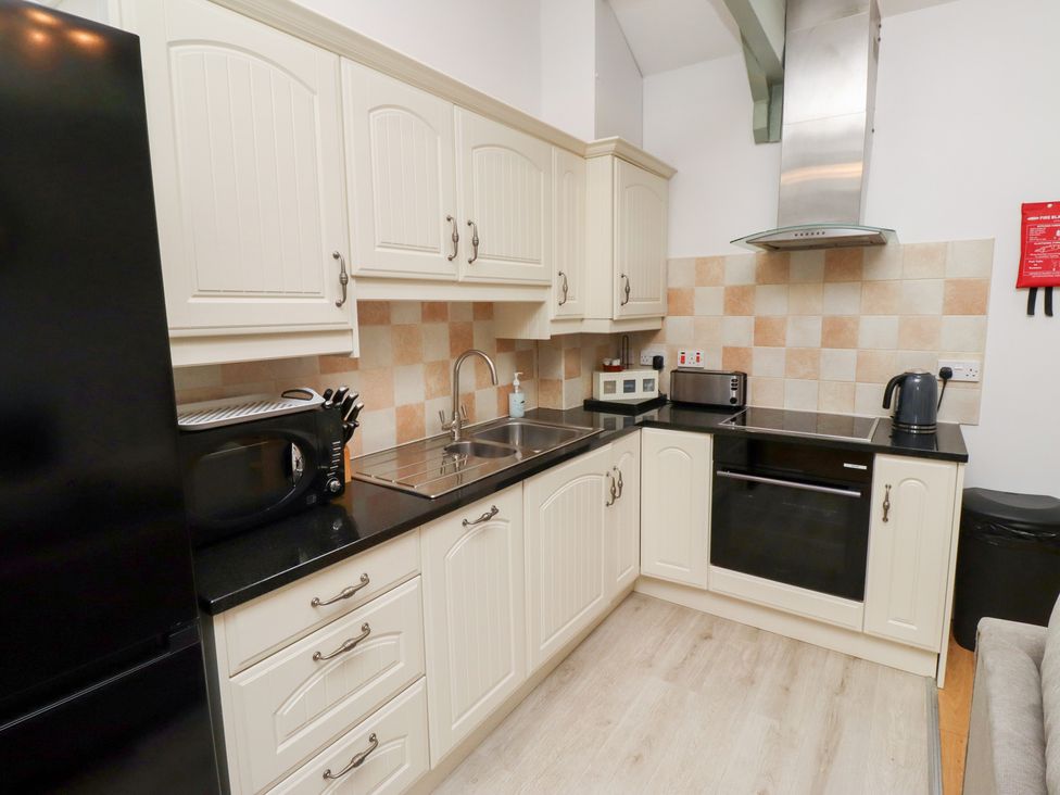 A kitchen with various appliances and cabinets at Chiff Chaff in Lucker