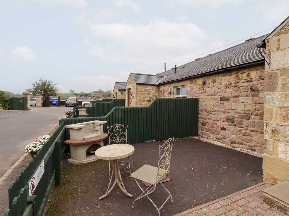 An outdoor area with a table and chair at Chiff Chaff in Lucker