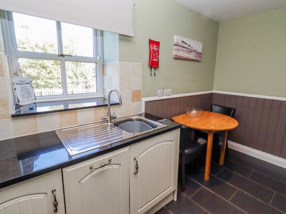 A kitchen with a sink and table at Greenfinch in Lucker