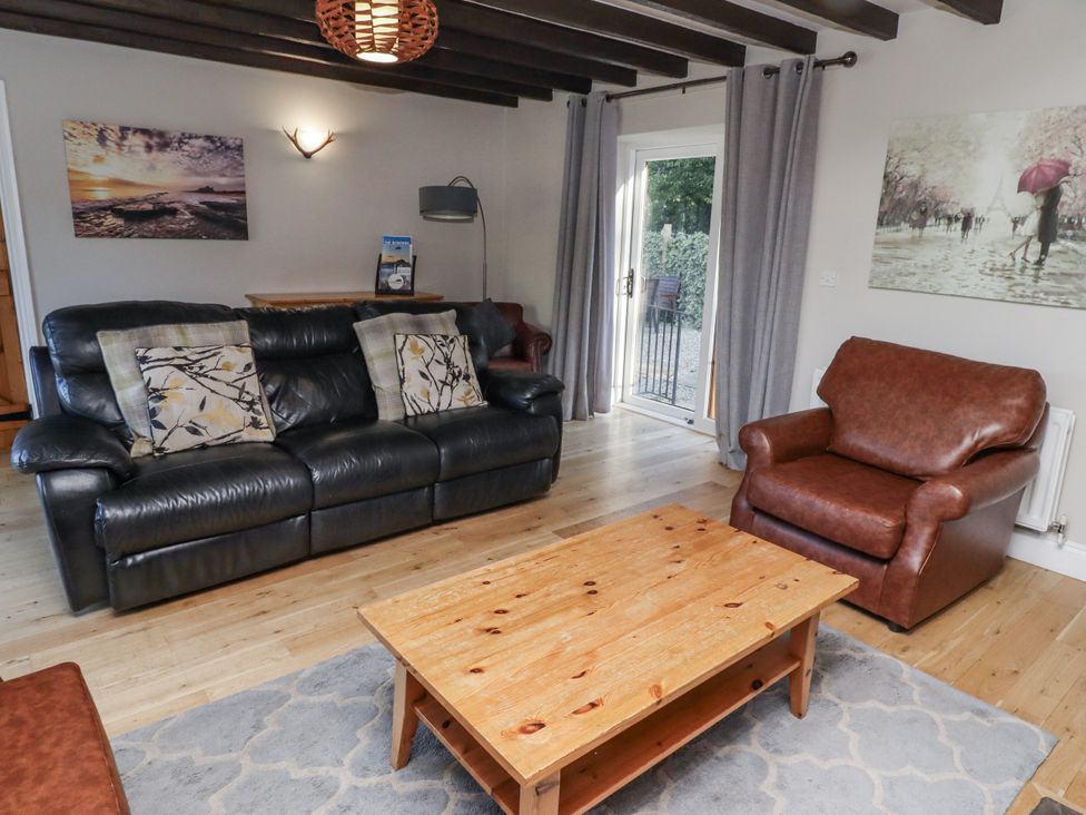 A living room with a sofa and armchair at Goldfinch in Lucker