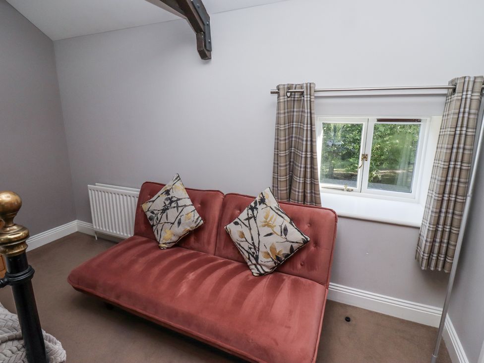 A snug with a sofa and window at Goldfinch in Lucker