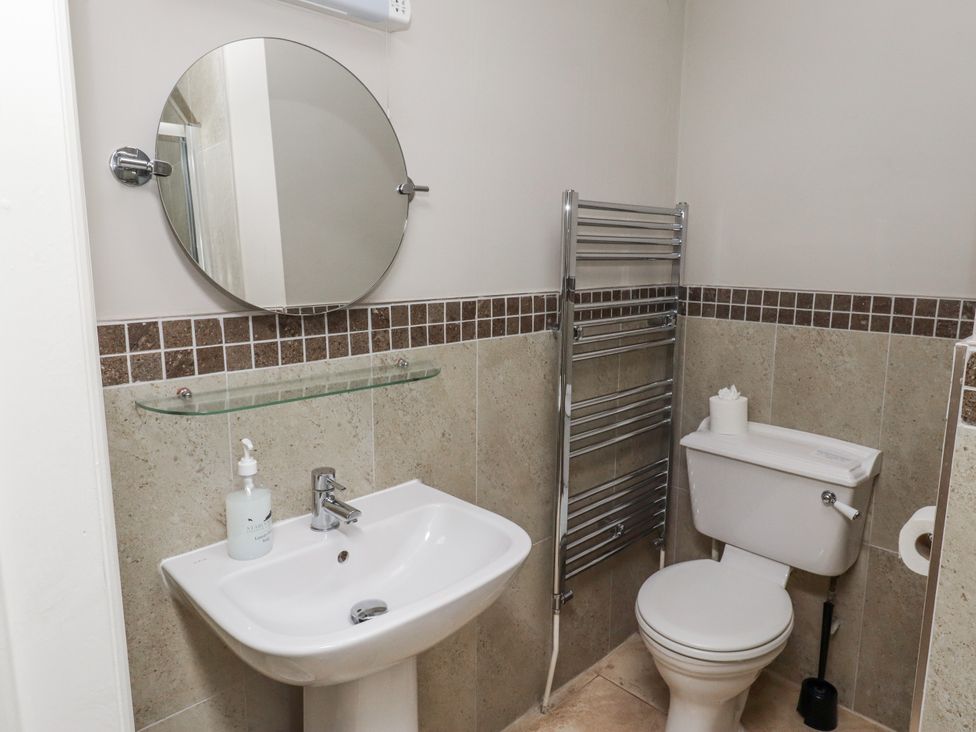 A bathroom with a sink, toilet, and towel rail at Goldfinch in Lucker