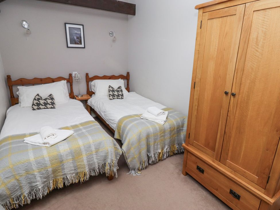 A bedroom with two beds and a wardrobe at Goldfinch in Lucker