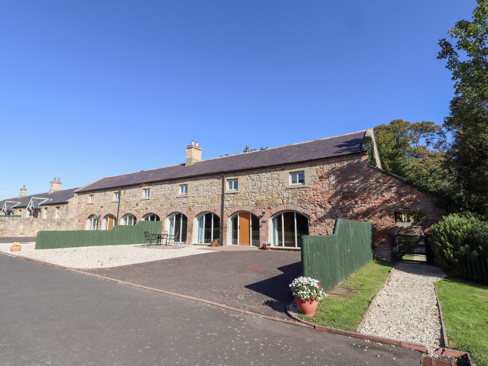An outdoor area in front of a stone building at Bullfinch in Lucker