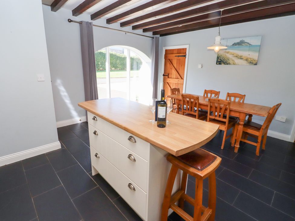 A kitchen with a countertop and dining table at Bullfinch in Lucker