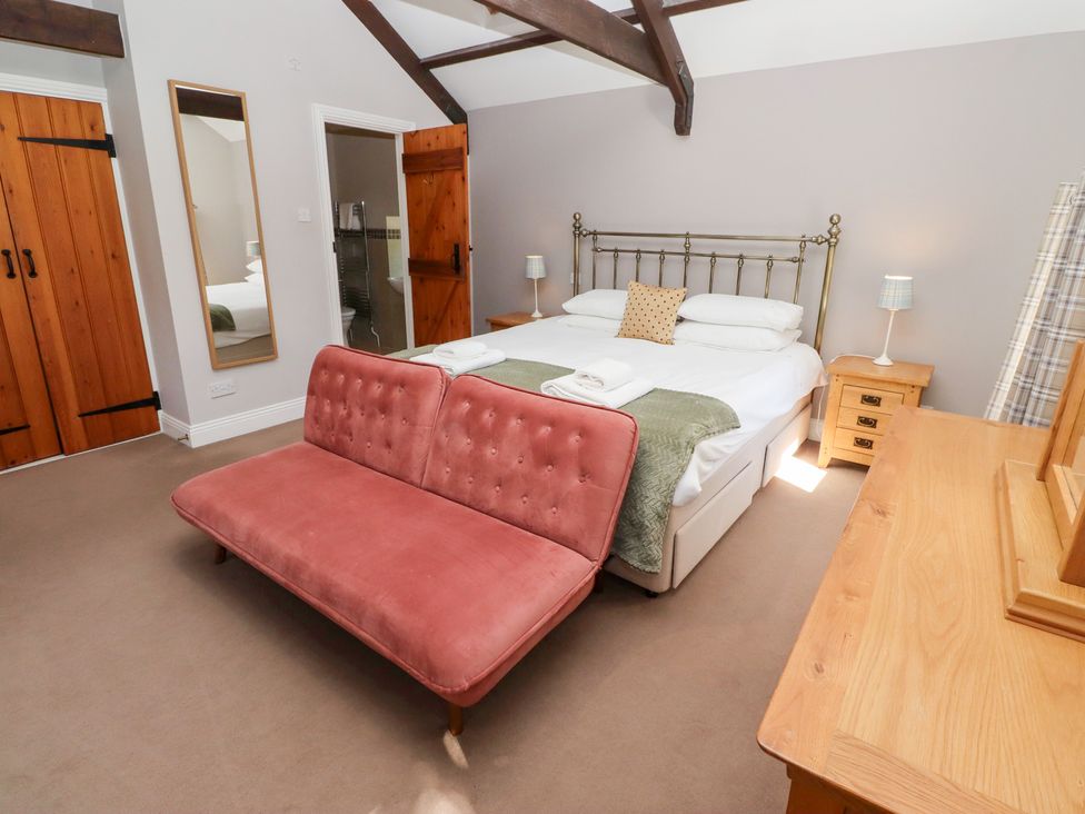 A bedroom with a bed and a sofa at Bullfinch in Lucker