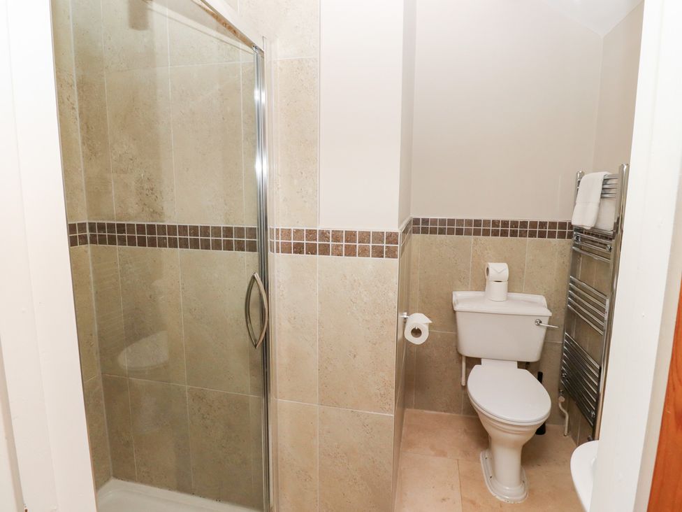 A bathroom with a shower and toilet at Bullfinch in Lucker