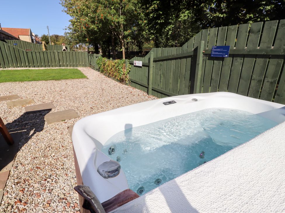 A hot tub in a garden at Bullfinch Lucker