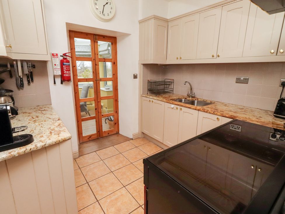 A kitchen with counter and appliances at Adderstone Cottage Bamburgh
