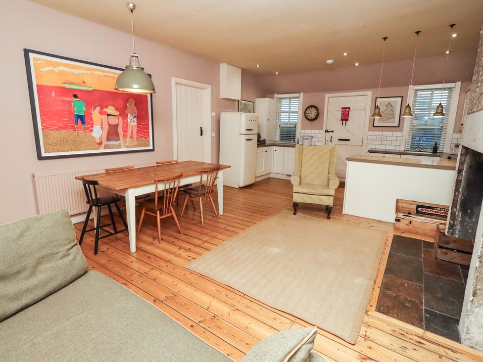 A kitchen with a dining table and chairs at Armstrong Cottages No6 Bamburgh