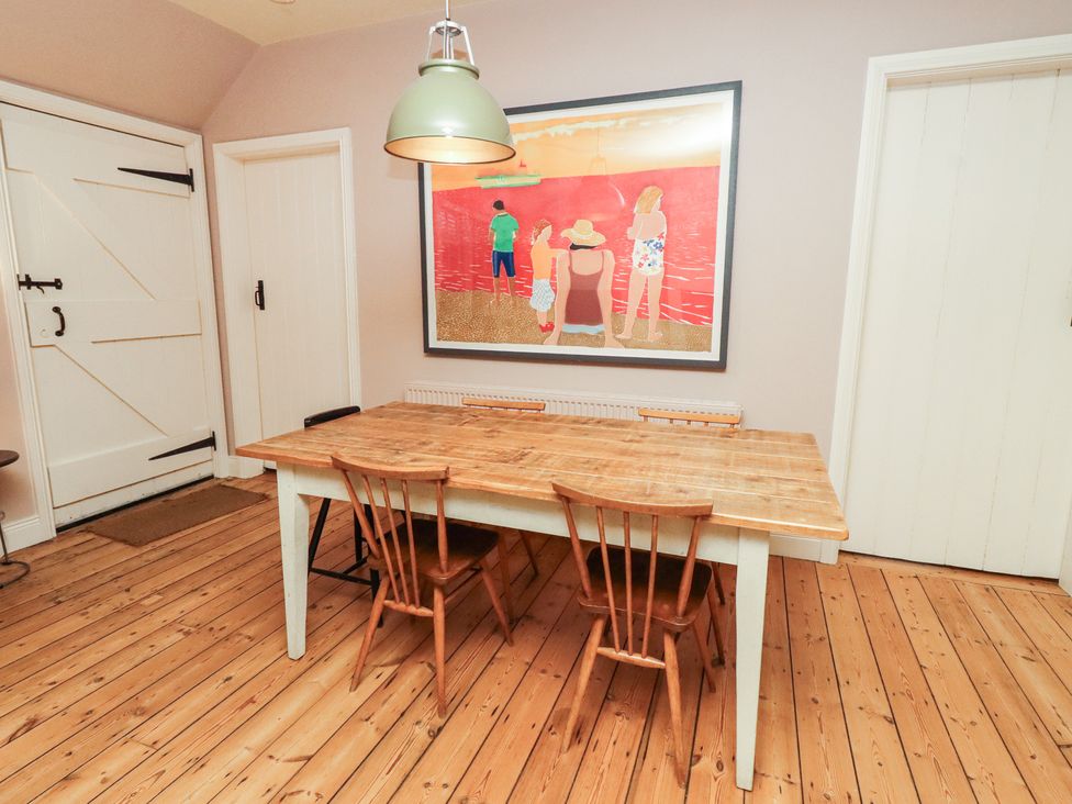 A dining room with a table and chairs at Armstrong Cottages No6 in Bamburgh