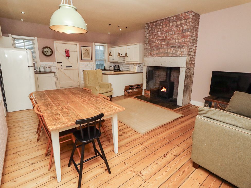 A kitchen with a table and chairs at Armstrong Cottages No6 Bamburgh