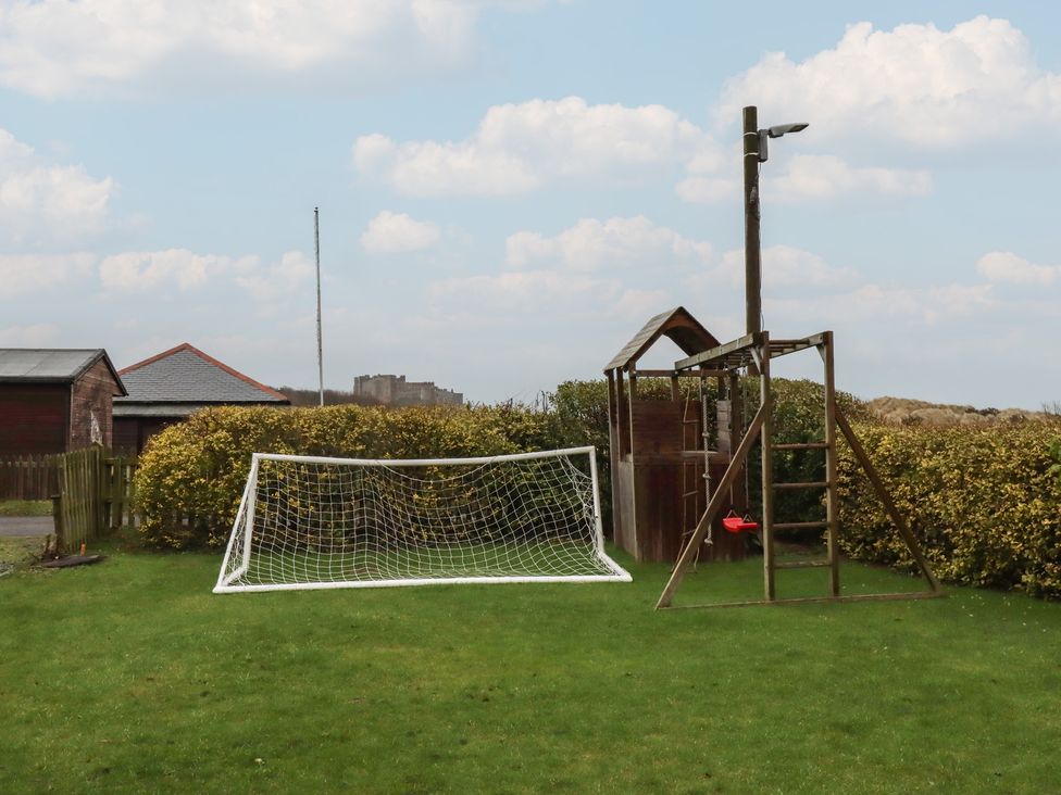 A soccer goal and playground structure in a yard at Armstrong Cottages No6 Bamburgh