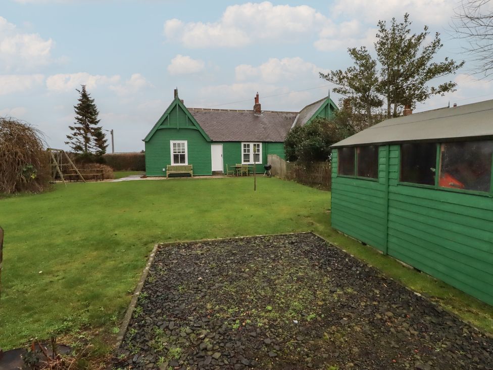 A garden with a green house and shed at Armstrong Cottages No6 Bamburgh