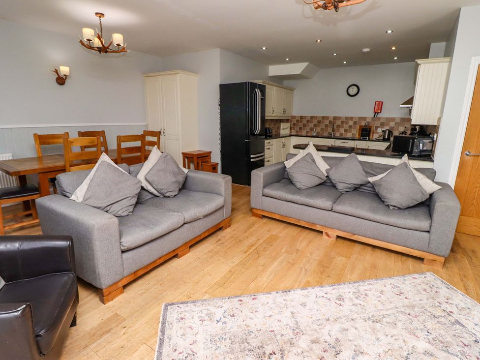 A living room with sofas and a dining table at Pipistrelle in Bamburgh