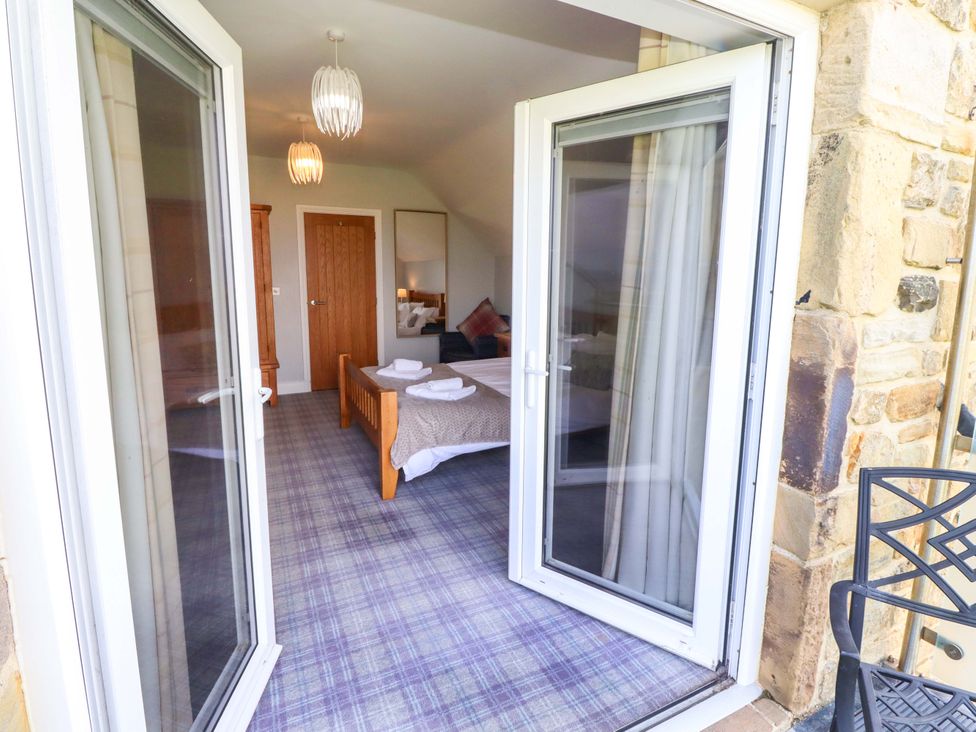 A bedroom with a bed and window at Pipistrelle in Bamburgh