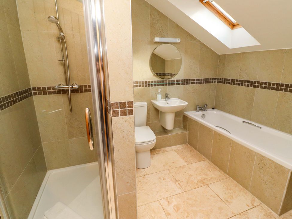 A bathroom with a shower, toilet, sink, and bathtub at Pipistrelle in Bamburgh