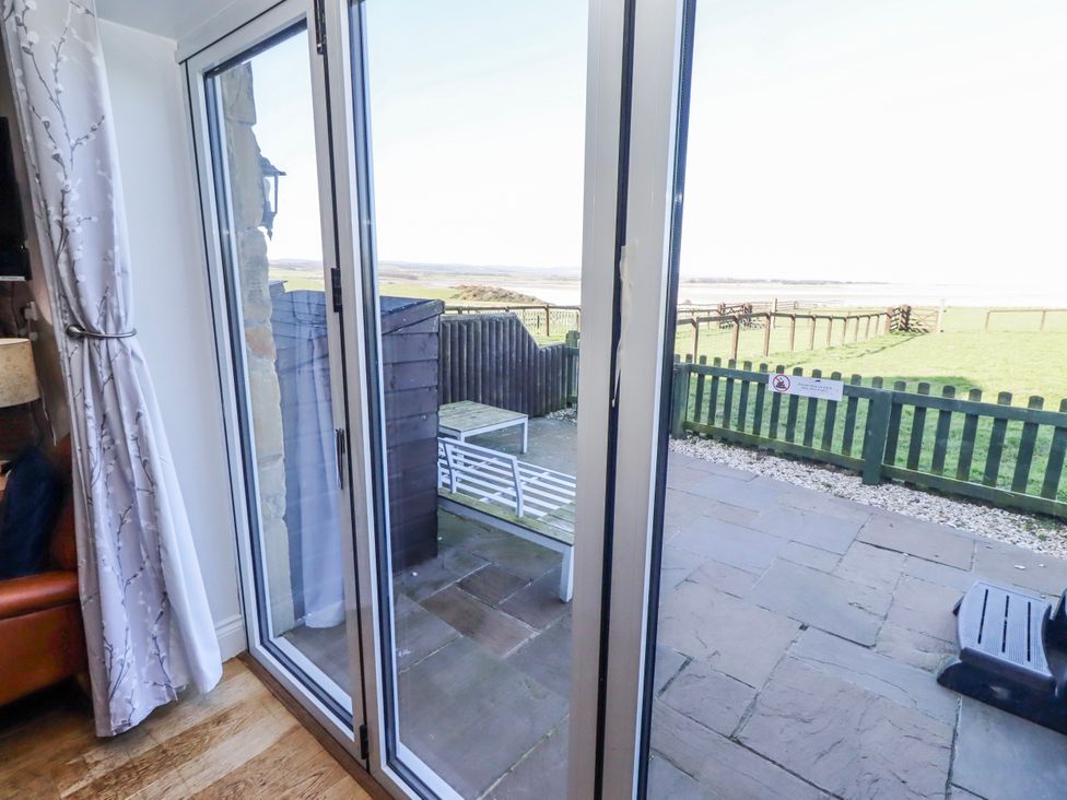 A view from a glass door to an outdoor area at Goosander in Bamburgh