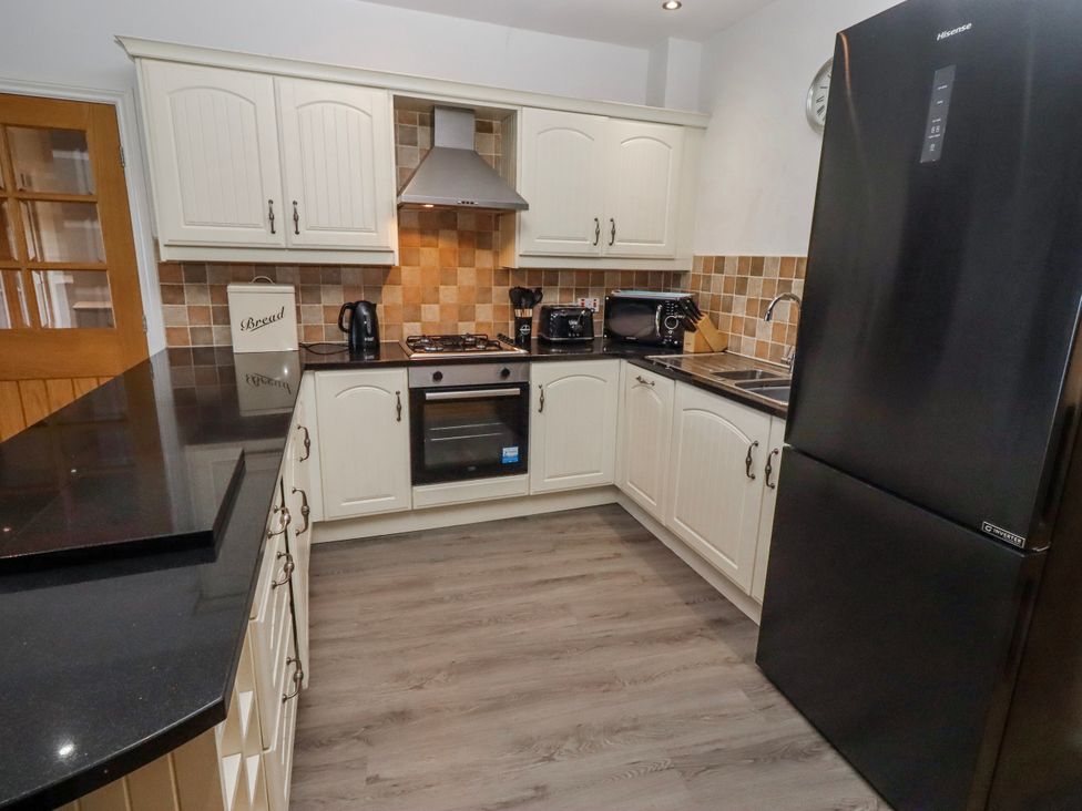 A kitchen with a refrigerator and oven at Goosander in Bamburgh