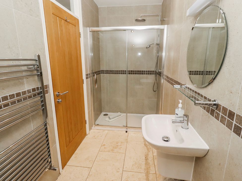 A bathroom with a shower and sink at Goosander in Bamburgh