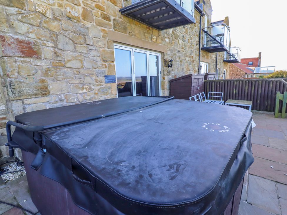 An outdoor patio featuring a hot tub at Goosander in Bamburgh