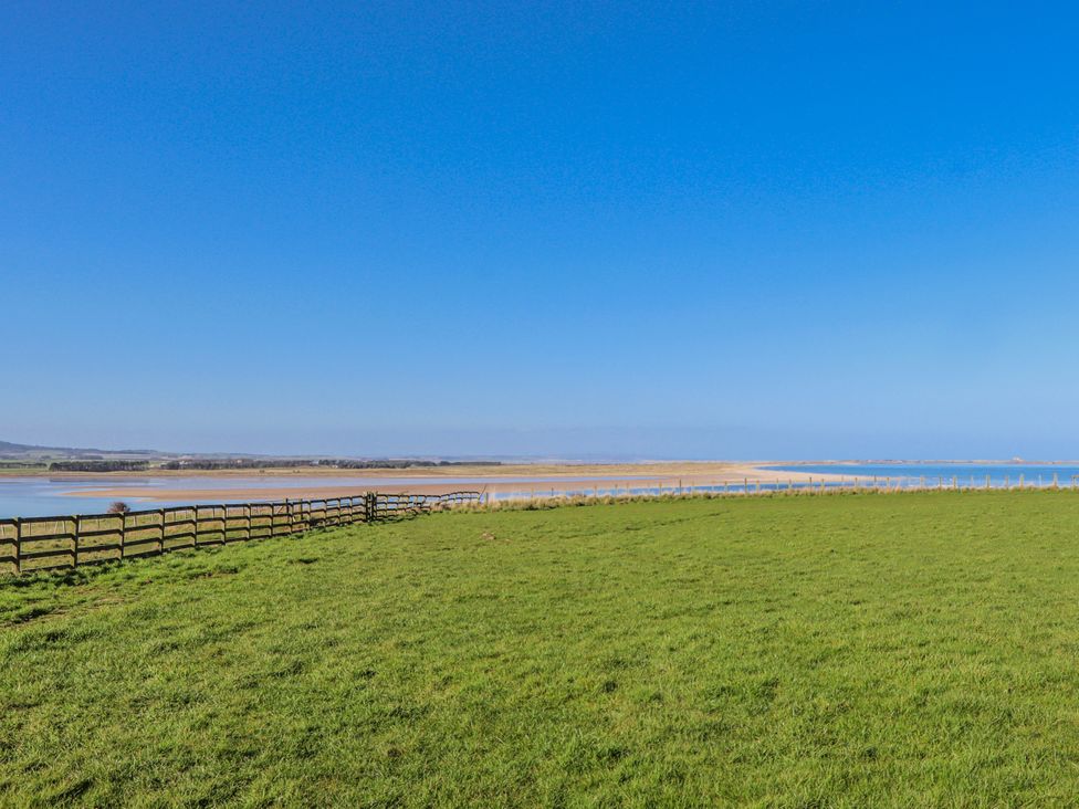 A view of grassland and water at Goosander in Bamburgh