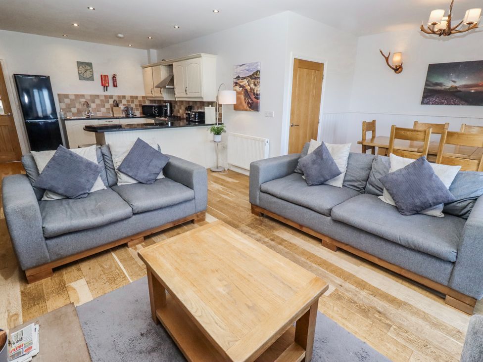 A living room with a sofa and coffee table at Jackdaw in Bamburgh