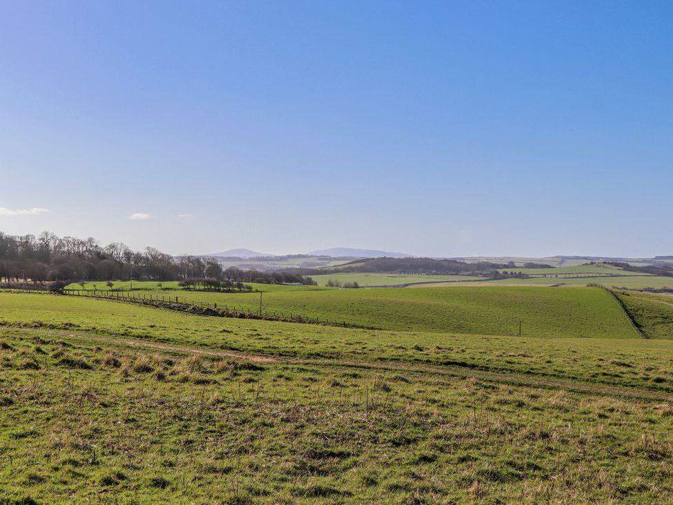 A landscape featuring a green field and hills at Jackdaw in Bamburgh
