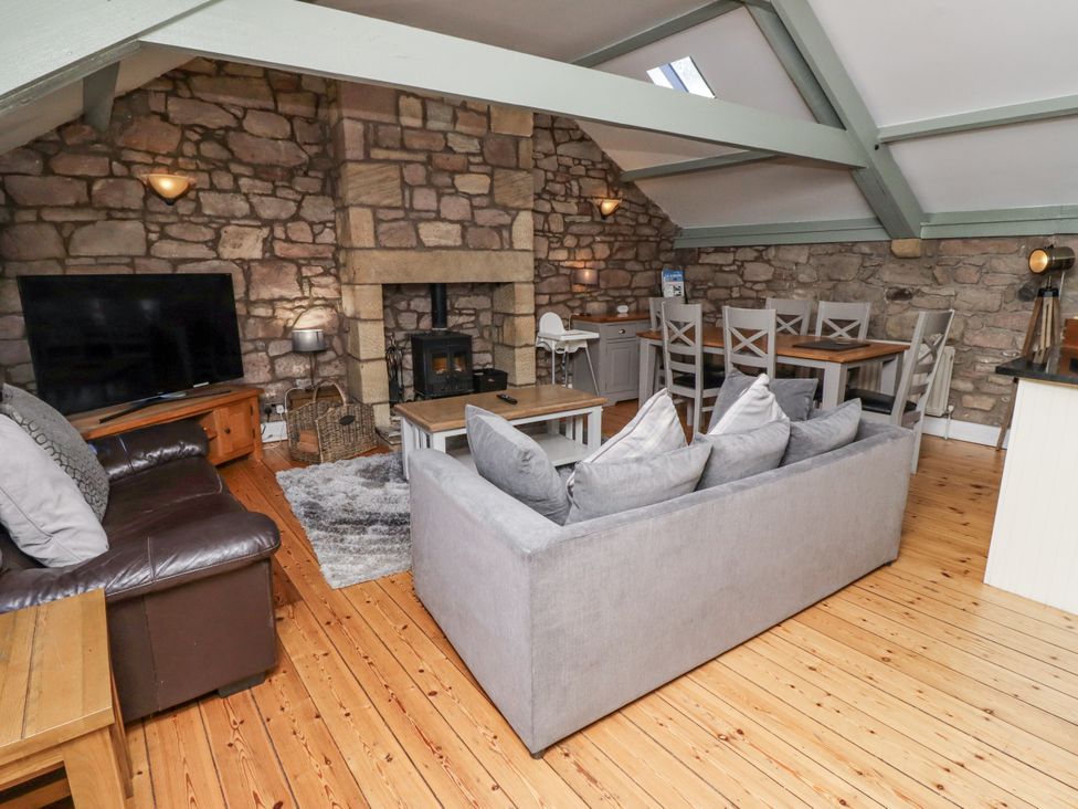 A living room with a sofa and television at Old Mill (Lucker) Lucker