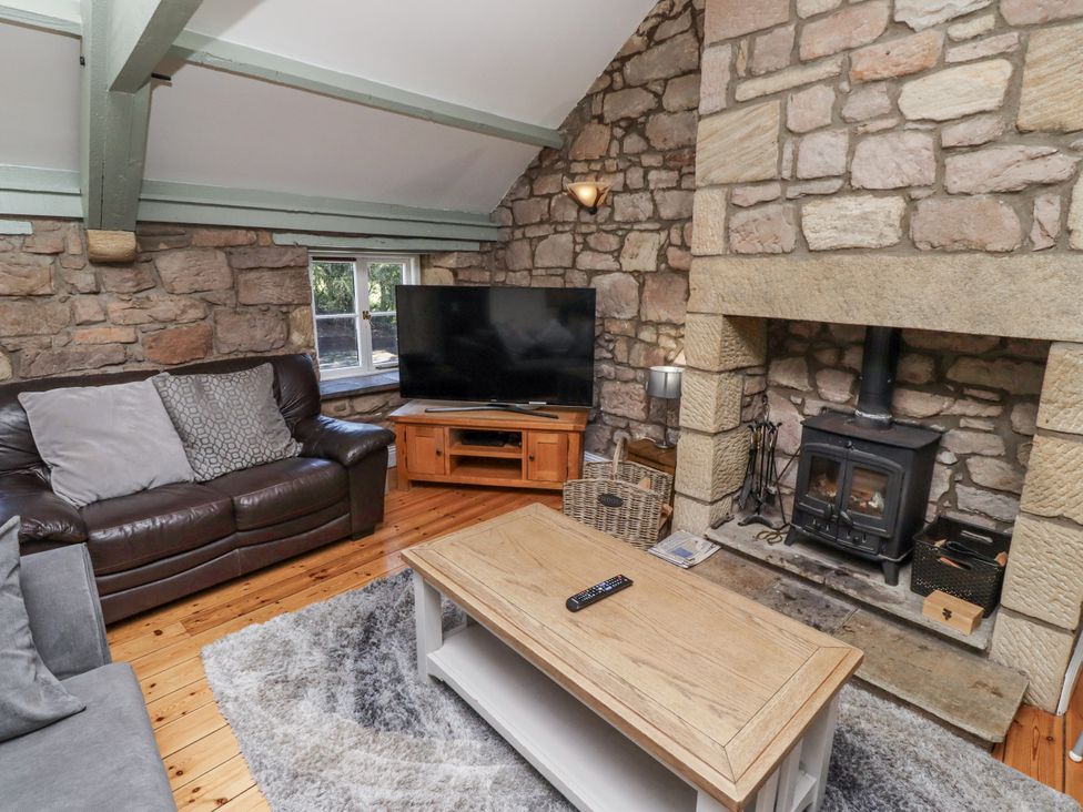 A living room with a sofa and television at Old Mill (Lucker) Lucker