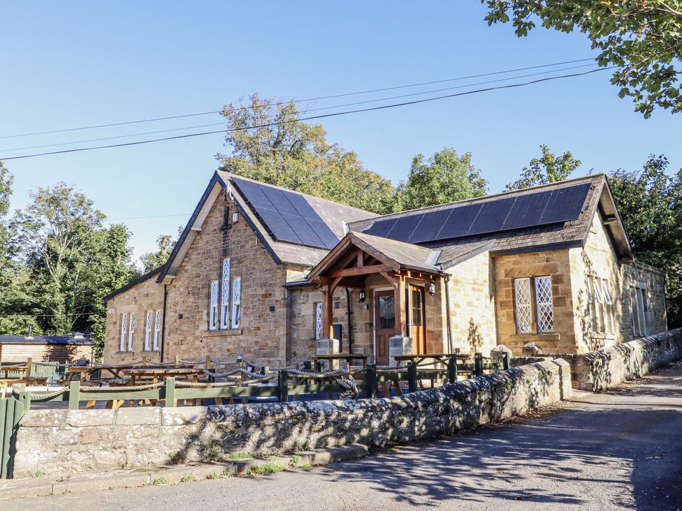 A building with solar panels and seating area at Old Mill (Lucker) Lucker