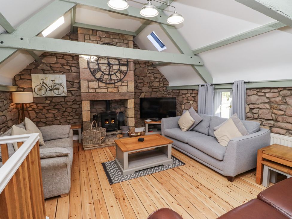A living room with a sofa and fireplace at Millstone in Lucker