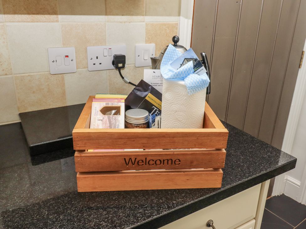 A welcome basket with paper towels and food items on a counter at Millstone in Lucker