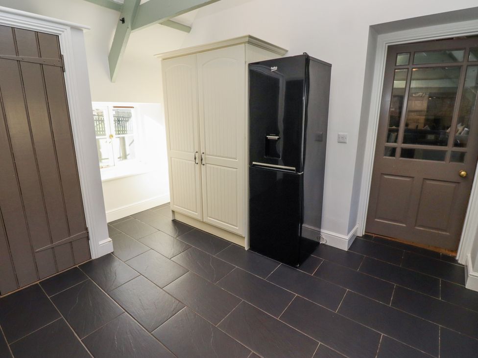 A kitchen with a refrigerator and storage cabinet at Millstone in Lucker