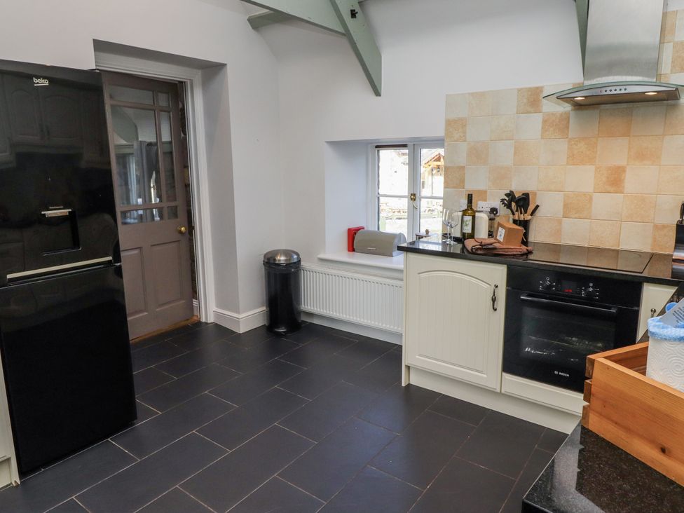 A kitchen with a refrigerator and oven at Millstone in Lucker