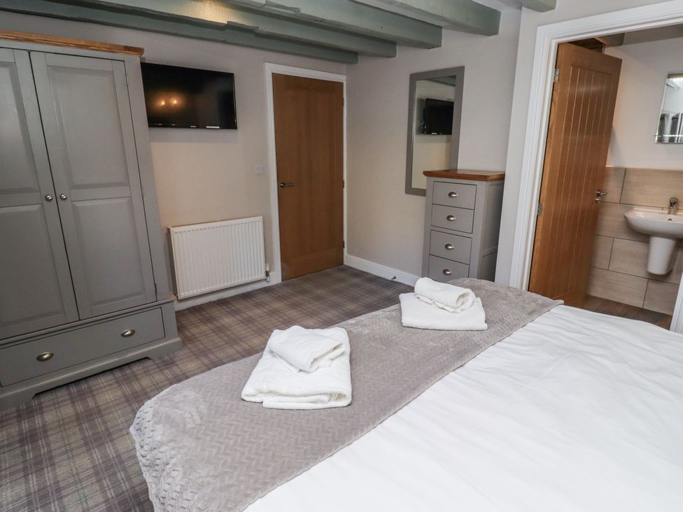 A bedroom with a bed and wardrobe at Millstone in Lucker