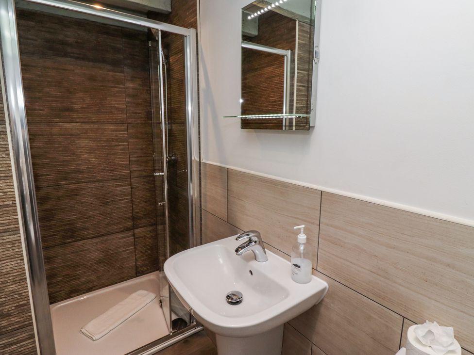 A bathroom with a shower and sink at Millstone in Lucker