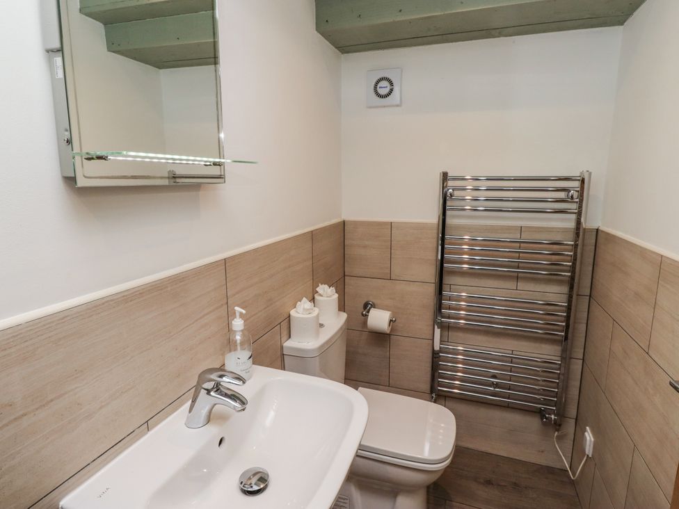 A bathroom with a sink and toilet at Millstone in Lucker