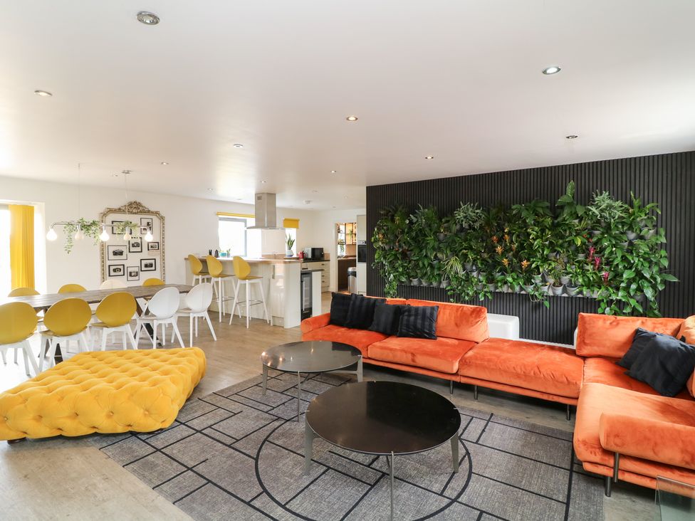 A living room with a sofa and dining area at Hayloft in Scampton