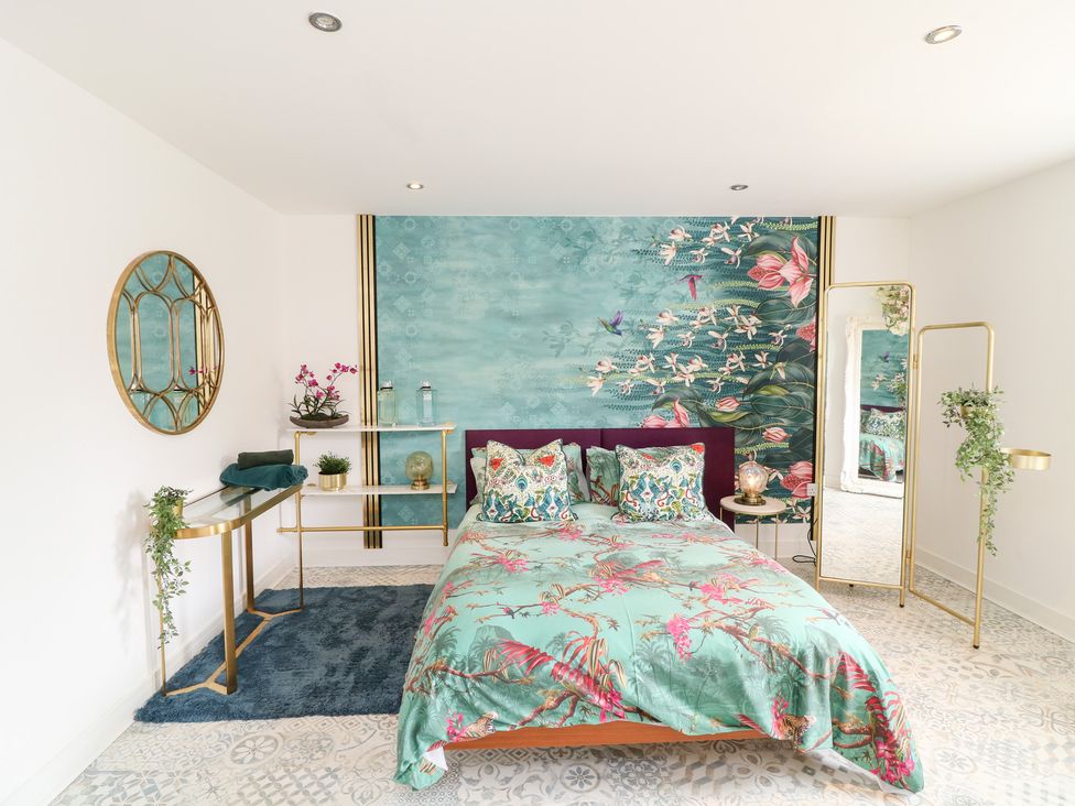 A bedroom with a bed and decorative wall art at Hayloft in Scampton