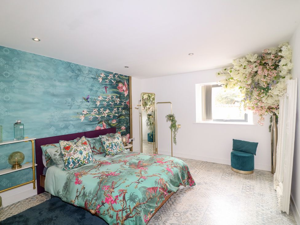 A bedroom with a bed and decorative elements at Hayloft in Scampton