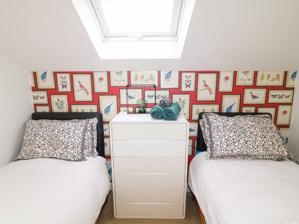 A bedroom with two beds and a dresser at Hayloft in Scampton