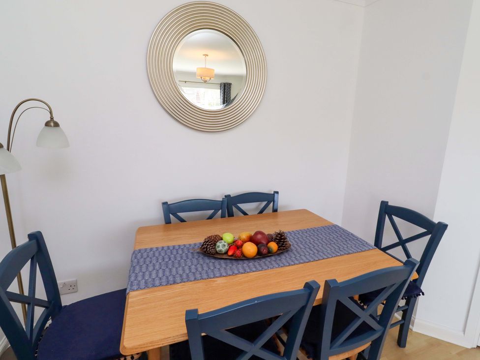 A dining room with a table and chairs at 6 Westview in Embleton